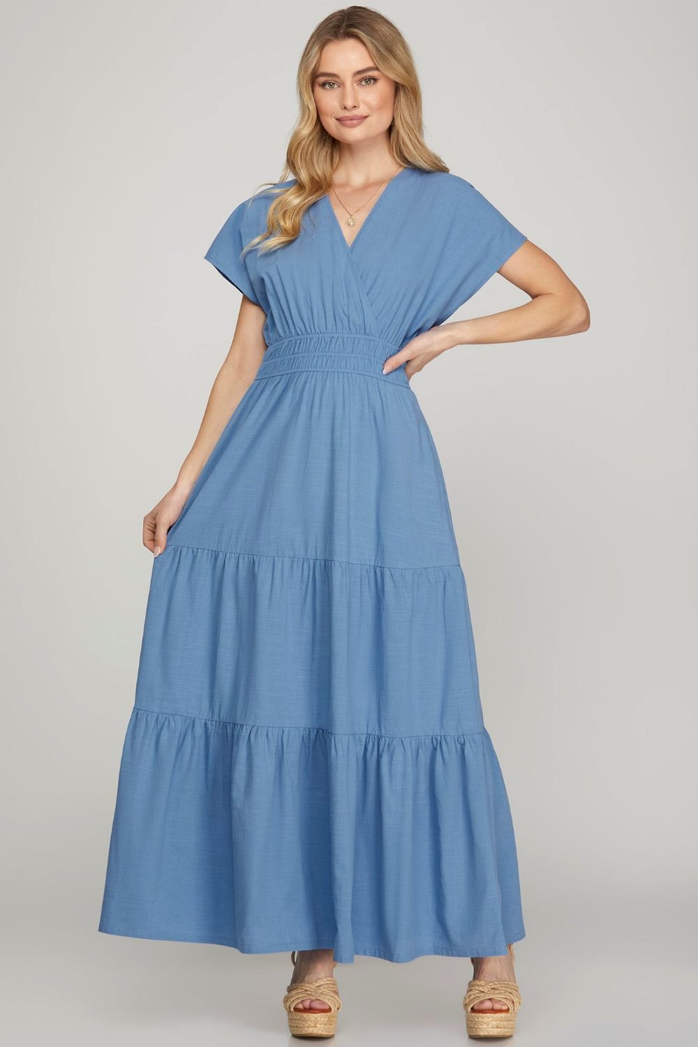 A tiered maxi dress with a surplice neckline and functional side pockets.