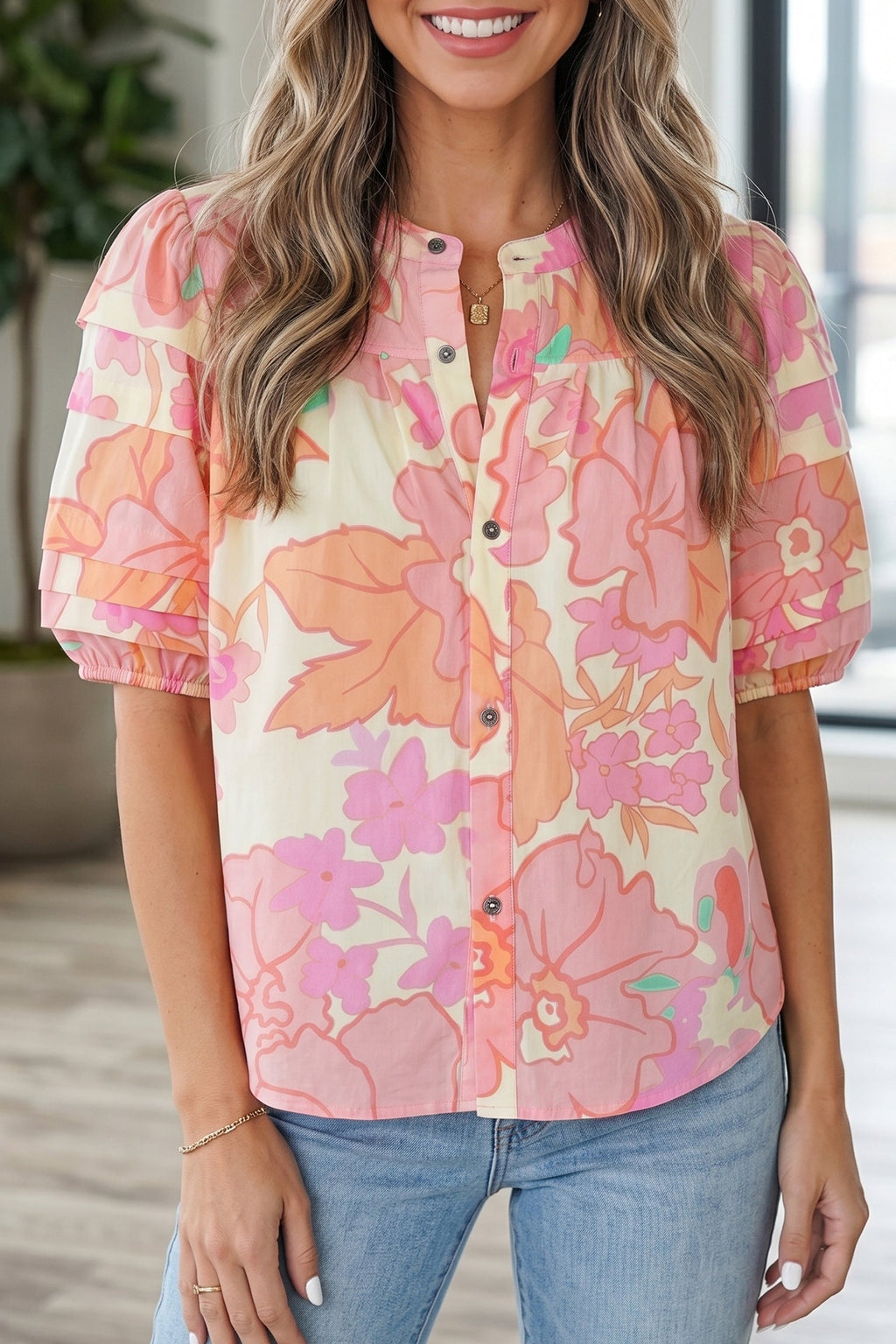 Woman wearing a pink, cream, and peach floral print cotton pintuck shirt with short sleeves