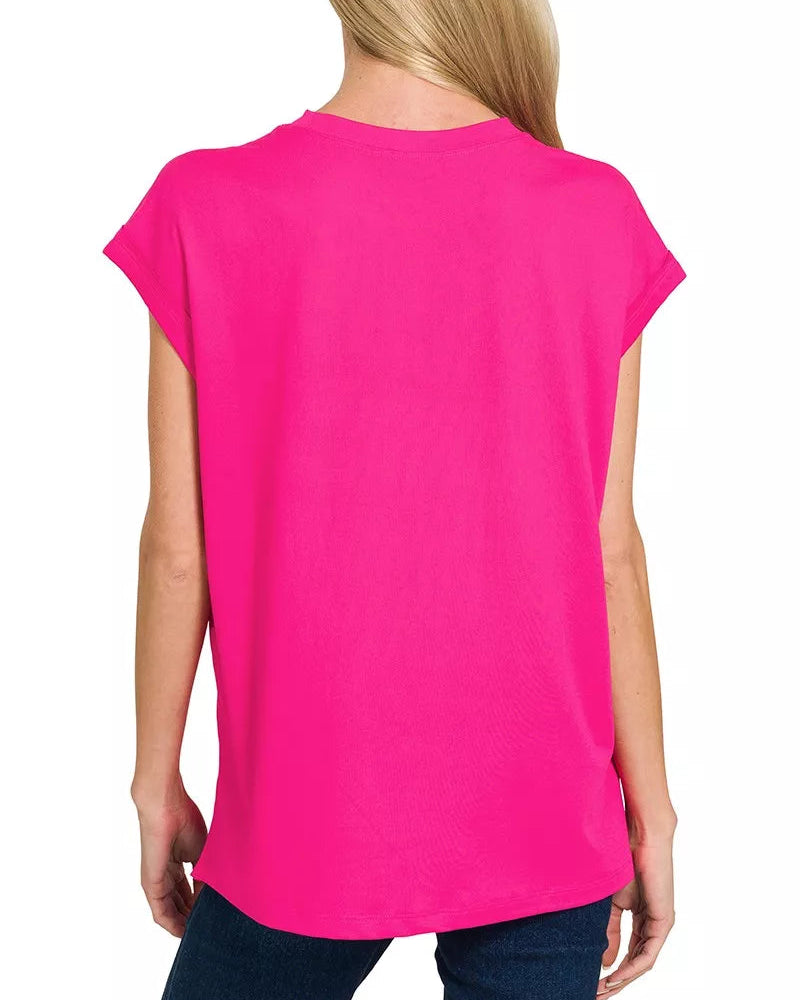 Person wearing a bright pink t-shirt on a white background