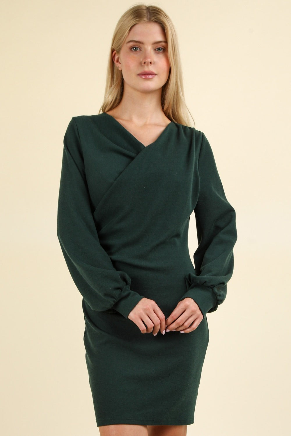 Dark green ruched bodycon mini dress with a figure-hugging minimalist silhouette.