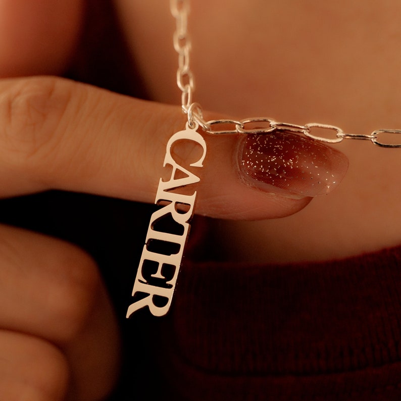 Customized cursive nameplate necklace on a high-quality chain, minimalist design.