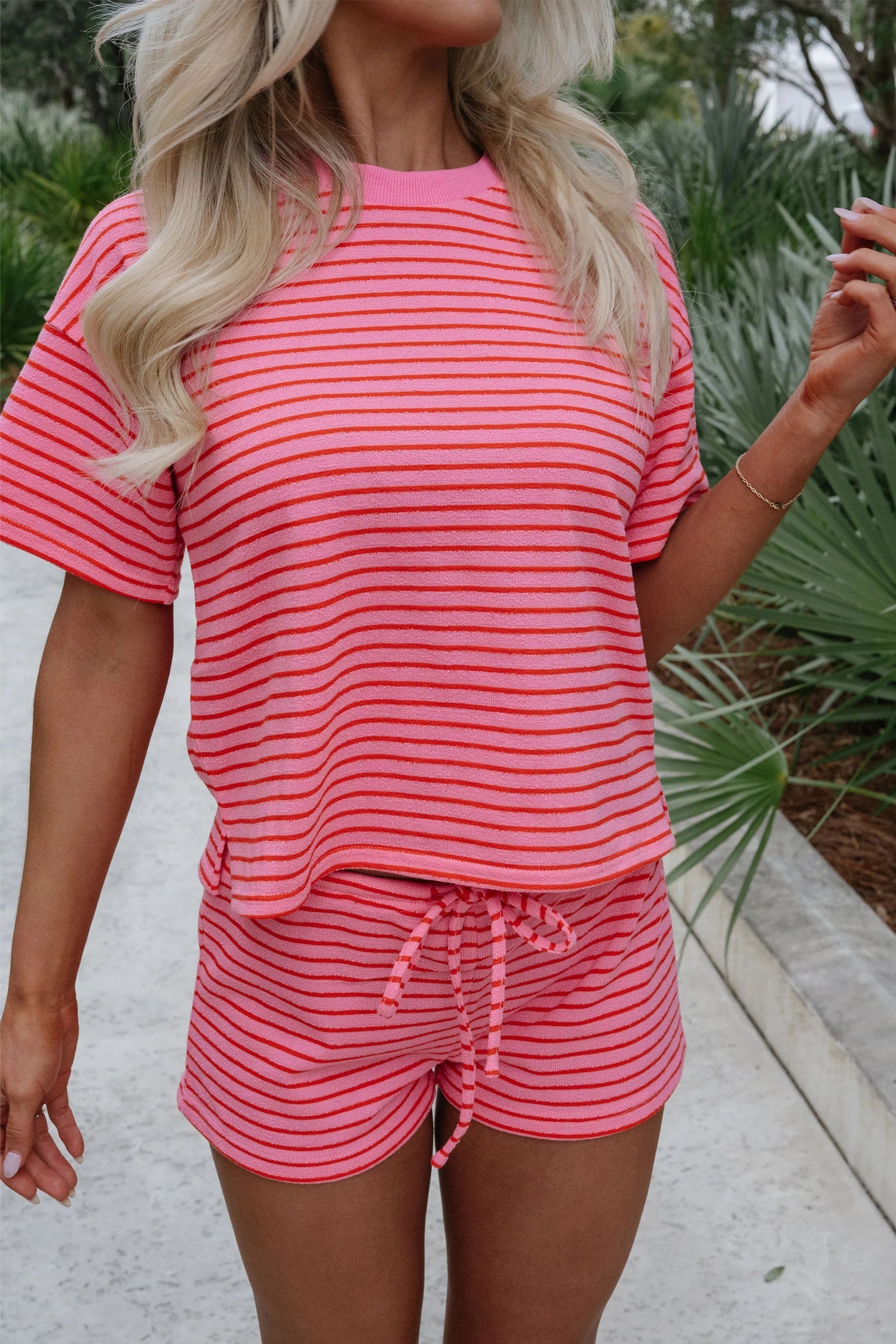 A comfortable rose-colored striped knit tee with a side split and matching drawstring shorts set.