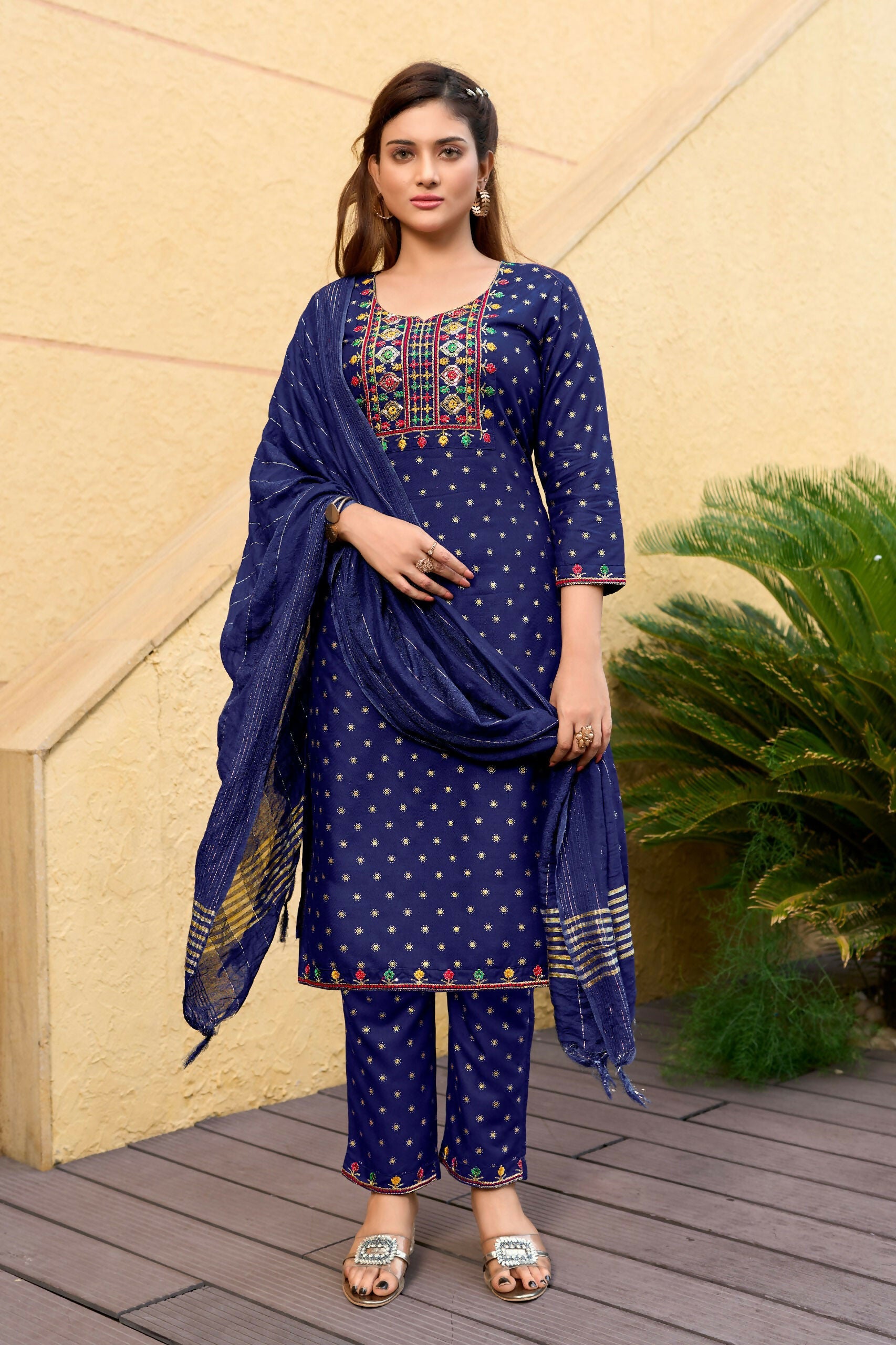 Woman wearing a blue 14KG rayon straight kurta with foil print and embroidery details