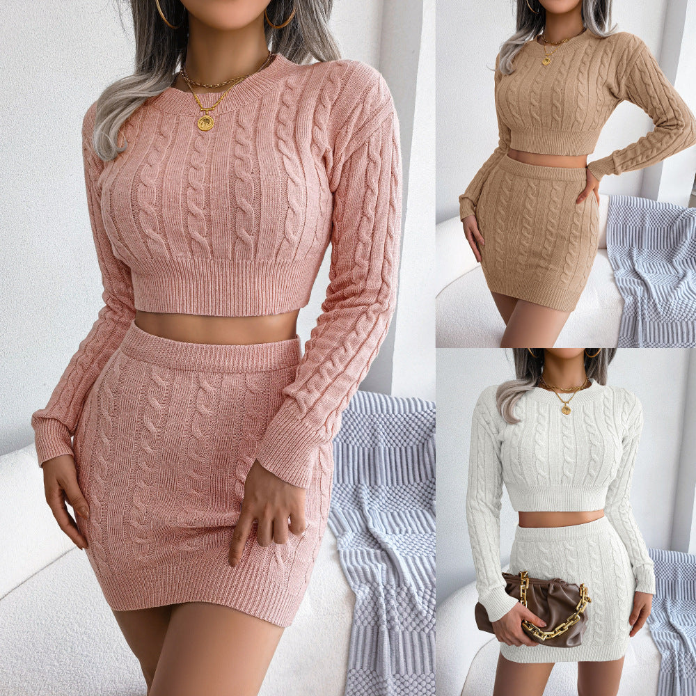 Model wearing a matching long-sleeve cable knit crop sweater and mini skirt set