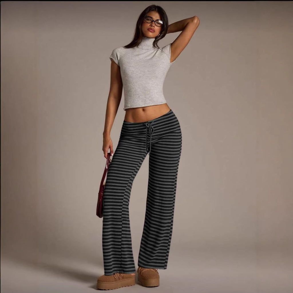 Model wearing dark grey and black striped wide-leg flared casual pants with a drawstring waist