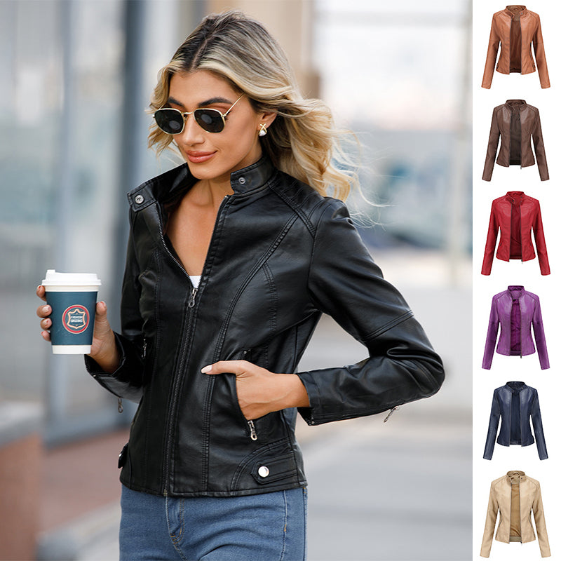 A woman wearing a black classic leather moto jacket with a zipper front and structured fit, paired with jeans.