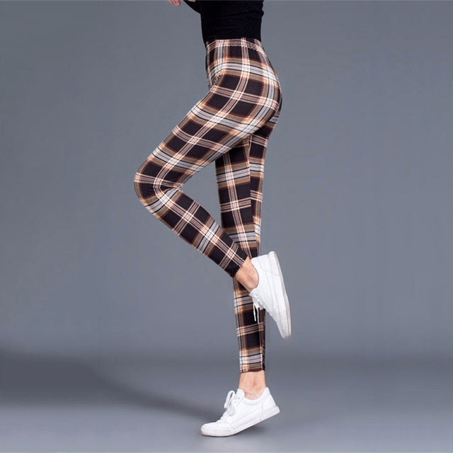 Women wearing fitted mid-waist plaid yoga leggings in a sporty, tapered silhouette