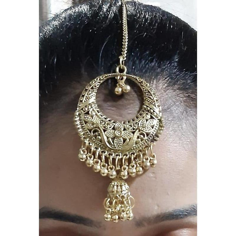 Antique gold plated traditional Chandbali Maang Tikka and hanging Jhumka earrings for Indian ethnic wear.