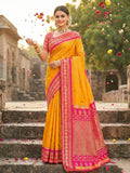 A beautiful yellow soft silk saree with a matching blouse piece