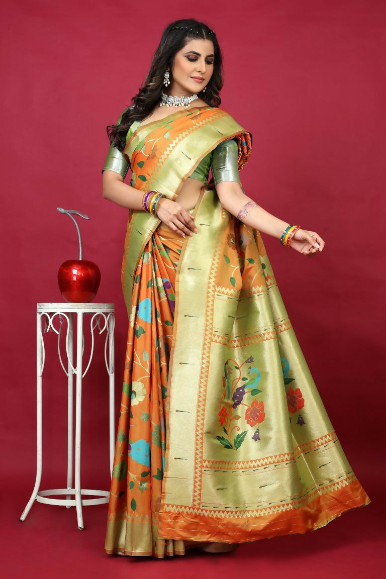 Orange Paithani silk saree with zari weaving and a contrasting green blouse.