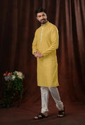 Light yellow art silk kurta paired with off-white pyjama pants