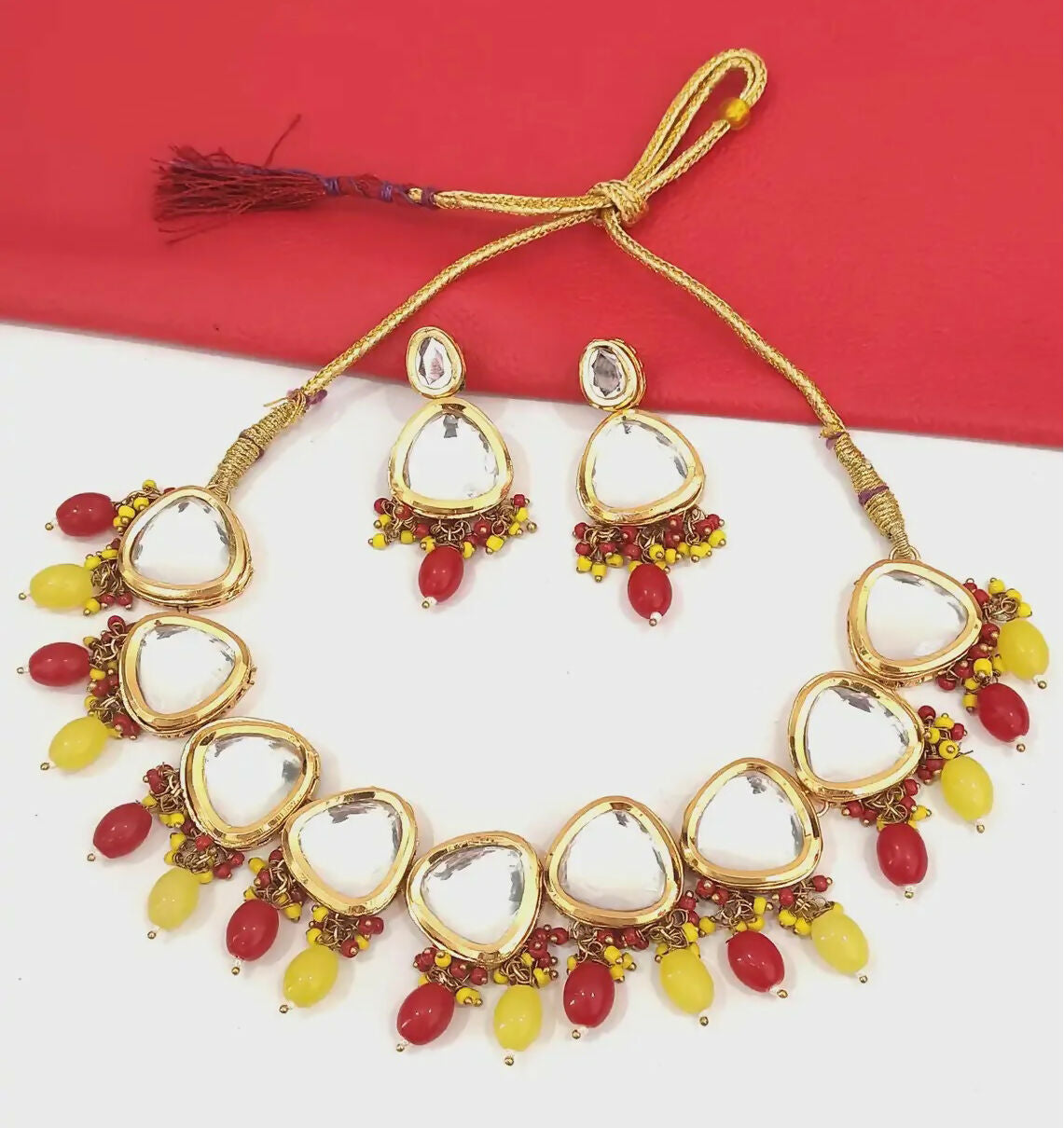 Gold-plated Kundan stone jewellery set on a luxury display