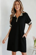 Jovie Trim preppy black and beige polo tee with quarter-zip closure and striped cuff details.