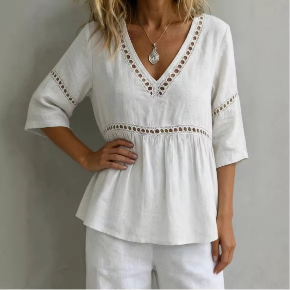 Model wearing a white V-neck cotton linen top with hollow-out trim and fringe details.