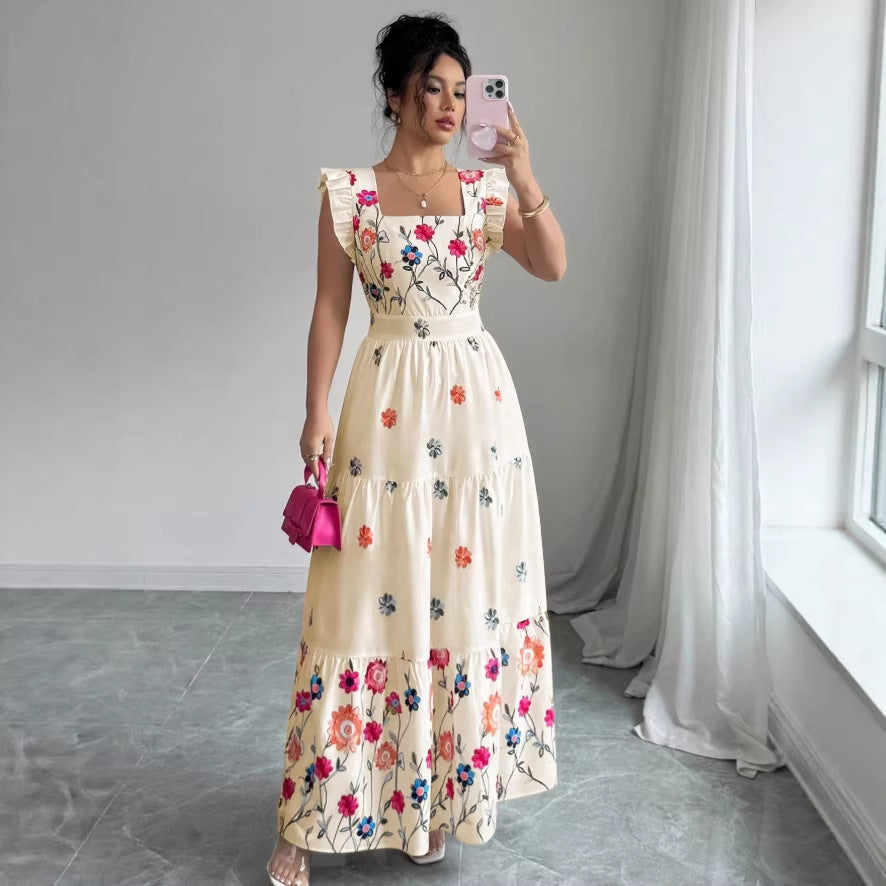 A romantic cream cotton midi dress with vibrant multi-colored floral print, square neckline, and puff sleeves.