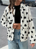 Model wearing a white zip-up jacket with black heart print featuring front pockets and elastic cuffs