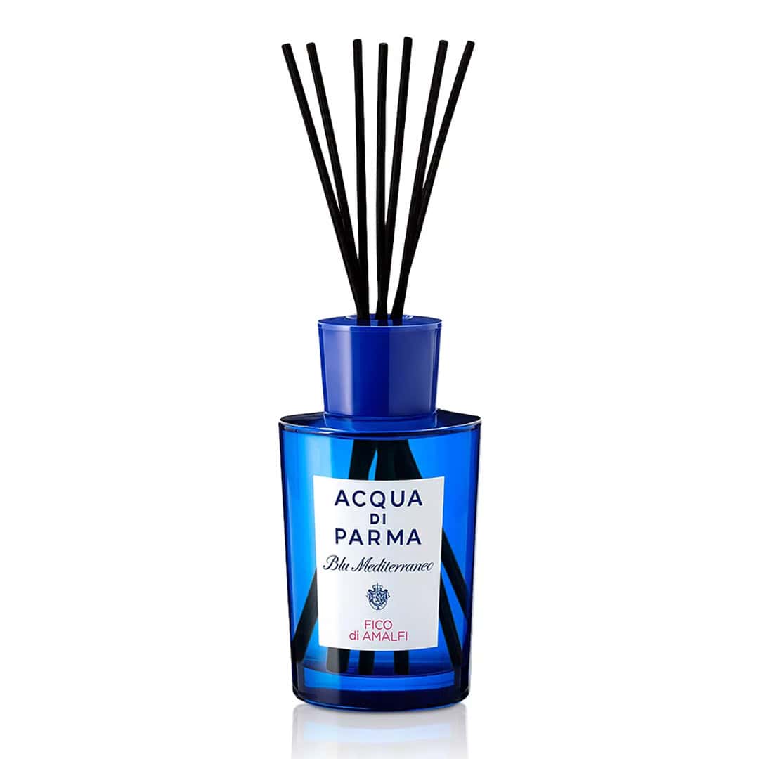 Acqua di Parma Blu Mediterraneo Fico di Amalfi room diffuser in a blue glass jar on a minimalist table.