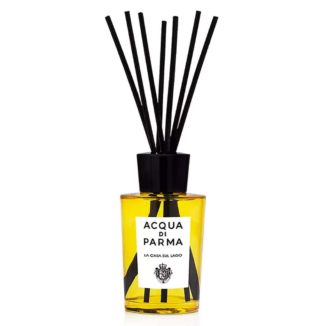 Acqua di Parma La Casa Sul Lago room diffuser in a vibrant yellow glass bottle with black accents.