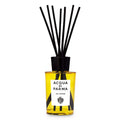 Modern glass room diffuser with amber yellow oil and black accents in a minimalist style