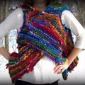 A knitted vest from the Adventure Cardi knitting kit laid flat, showcasing the texture and pattern.