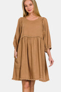Washed linen babydoll dress featuring puff sleeves and pleated detailing