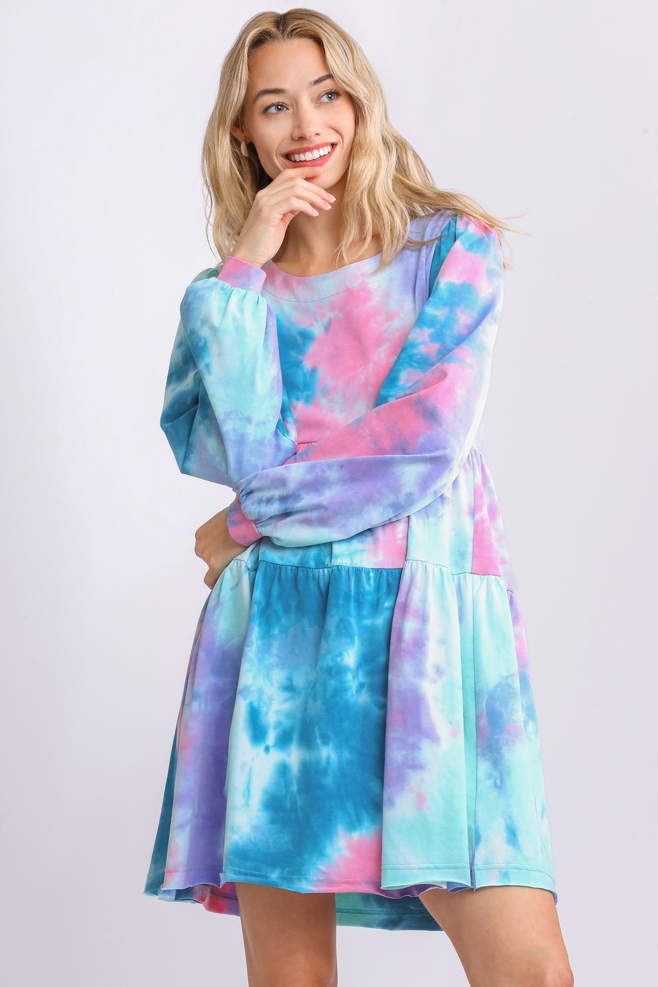 A beautiful long sleeve boho dress featuring a vibrant print in blue, pink, and purple