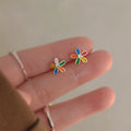 A pair of elegant, minimalist gold-plated heart stud earrings on a clean background.