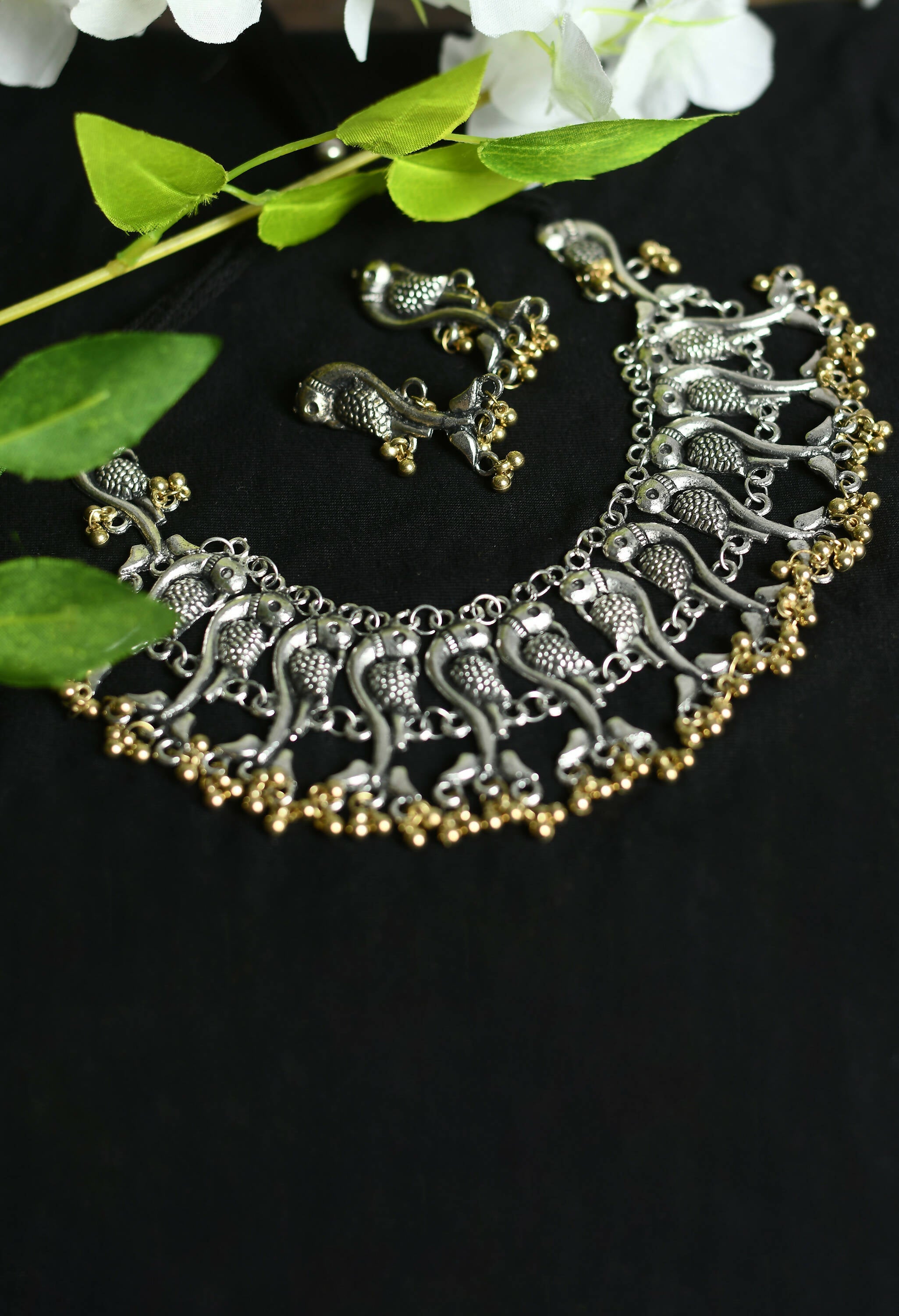 Close-up of an oxidised silver-plated peacock choker with dual-tone brass finish