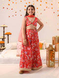 Front view of a girl's orange cotton lehenga choli set with a sheer net dupatta