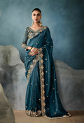 Teal tissue fabric party saree with sequin embellishments and zari work