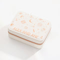 White leather jewelry case with geometric pattern and rose-gold zipper detailing.