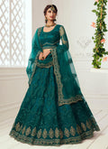 Teal green net wedding lehenga with heavy embroidery, including choli and dupatta