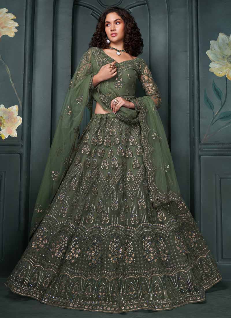 A luxurious mehendi green net bridal lehenga with intricate gold embroidery for traditional Indian wedding ceremonies.