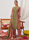 A woman wearing a peach organza embroidered party wear suit with Gota Patti detail