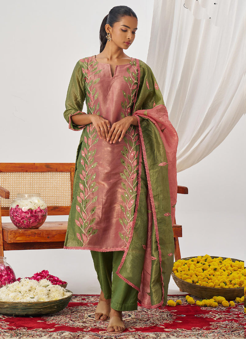 Close up of peach organza suit with intricate embroidery and shimmering gota patti work
