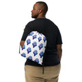 A man wearing a white drawstring gym backpack with a purple and teal basketball logo pattern.