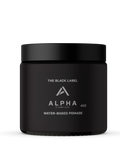 Black jar of Alpha Water Based Pomade with professional branding held by a man in a suit