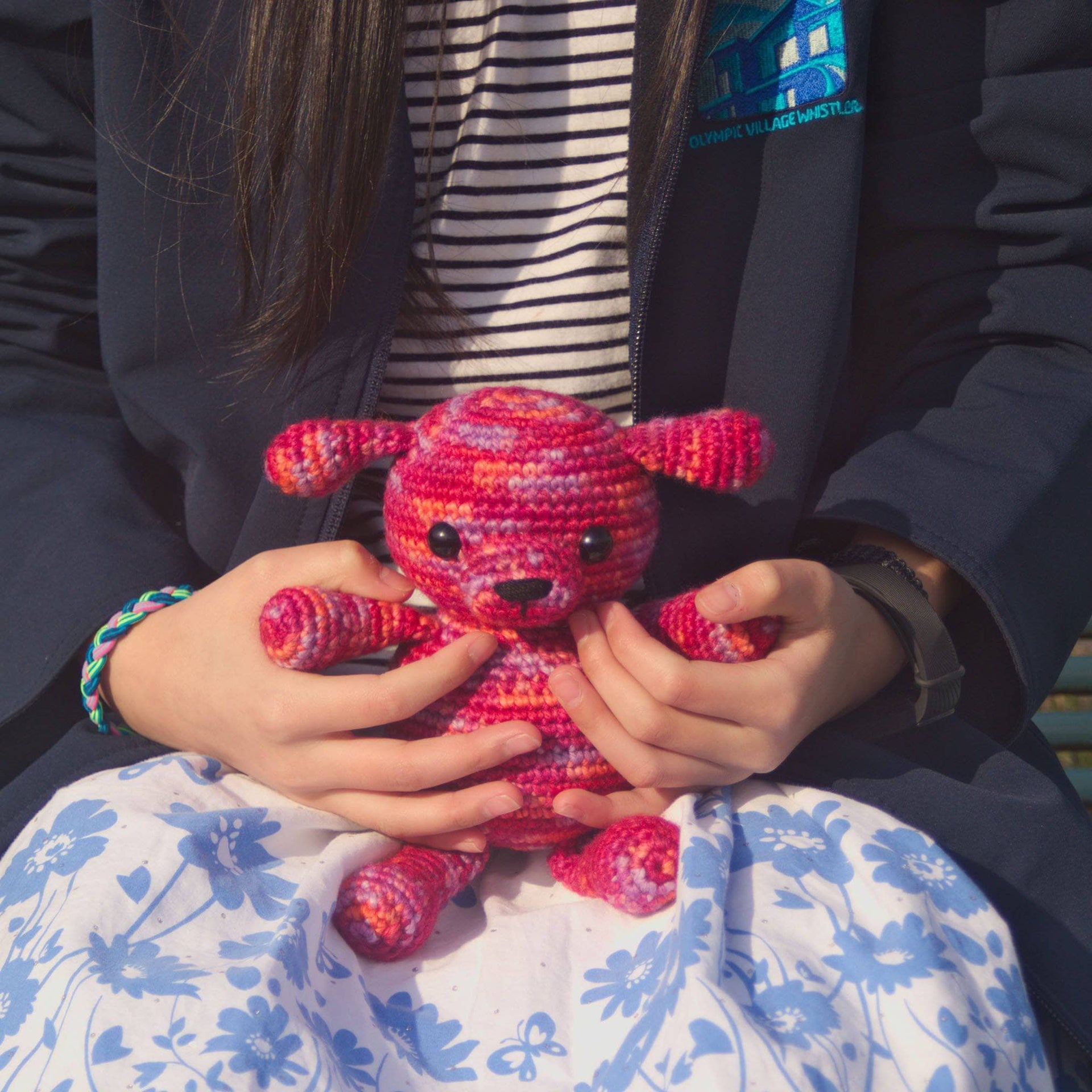 A finished handmade Amigurumi puppy crochet stuffed animal made from yarn.