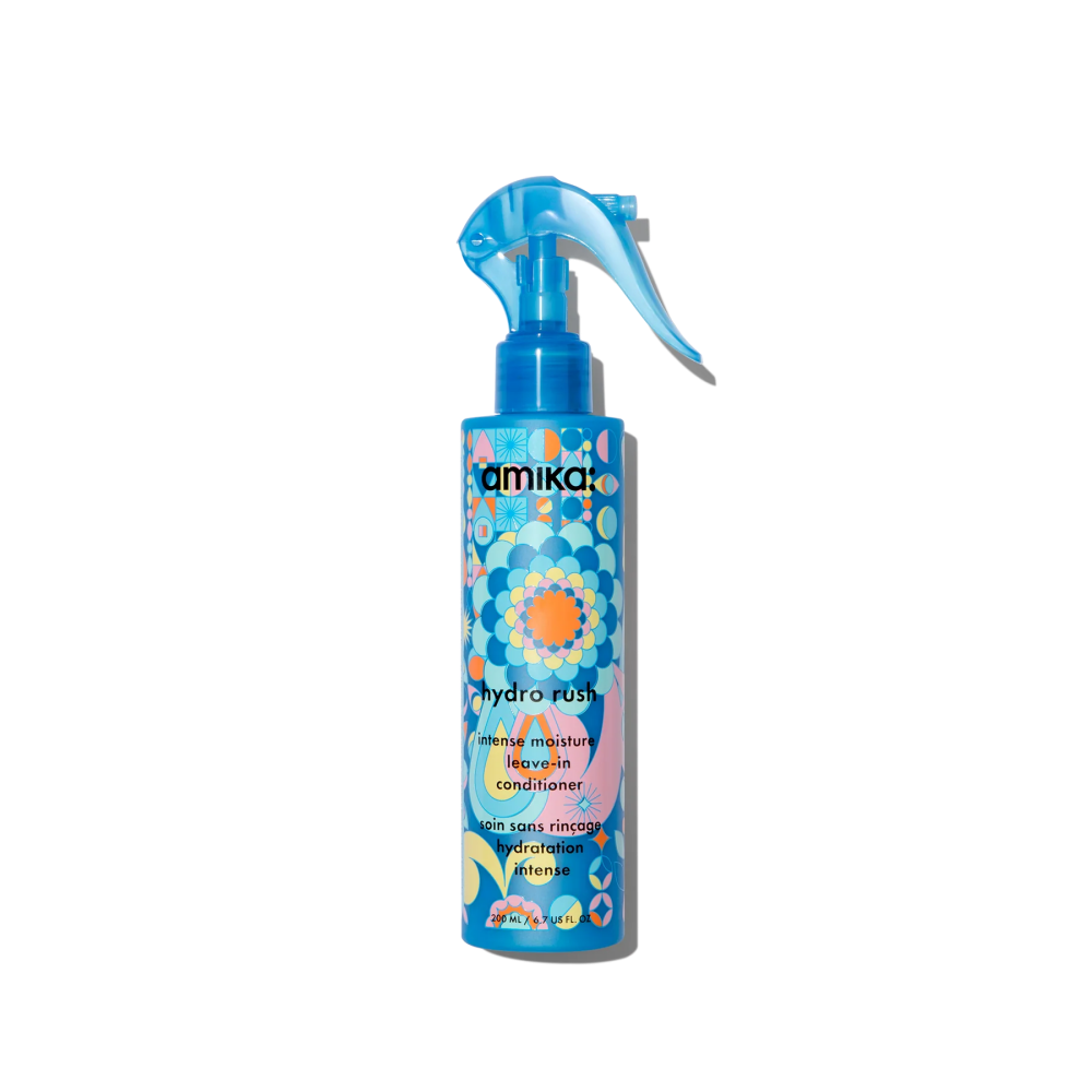 Amika Hydro Rush Intense Moisture Leave-In Conditioner bottle with vibrant blue, pink, and orange psychedelic pattern.