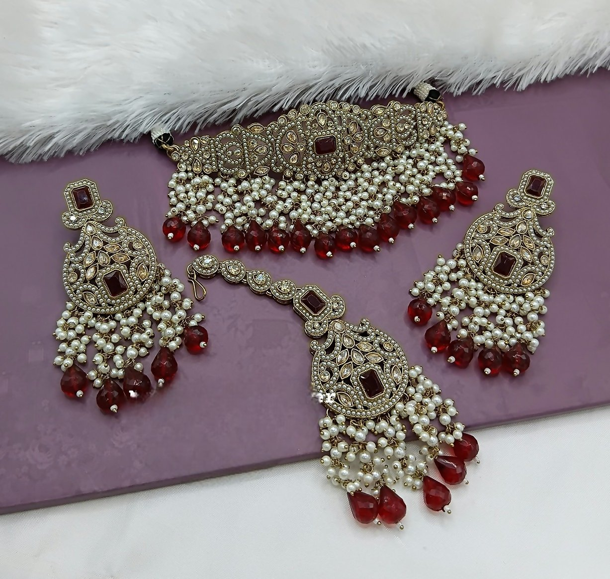 Sophisticated maroon alloy choker necklace set with a rich finish for a luxurious look.