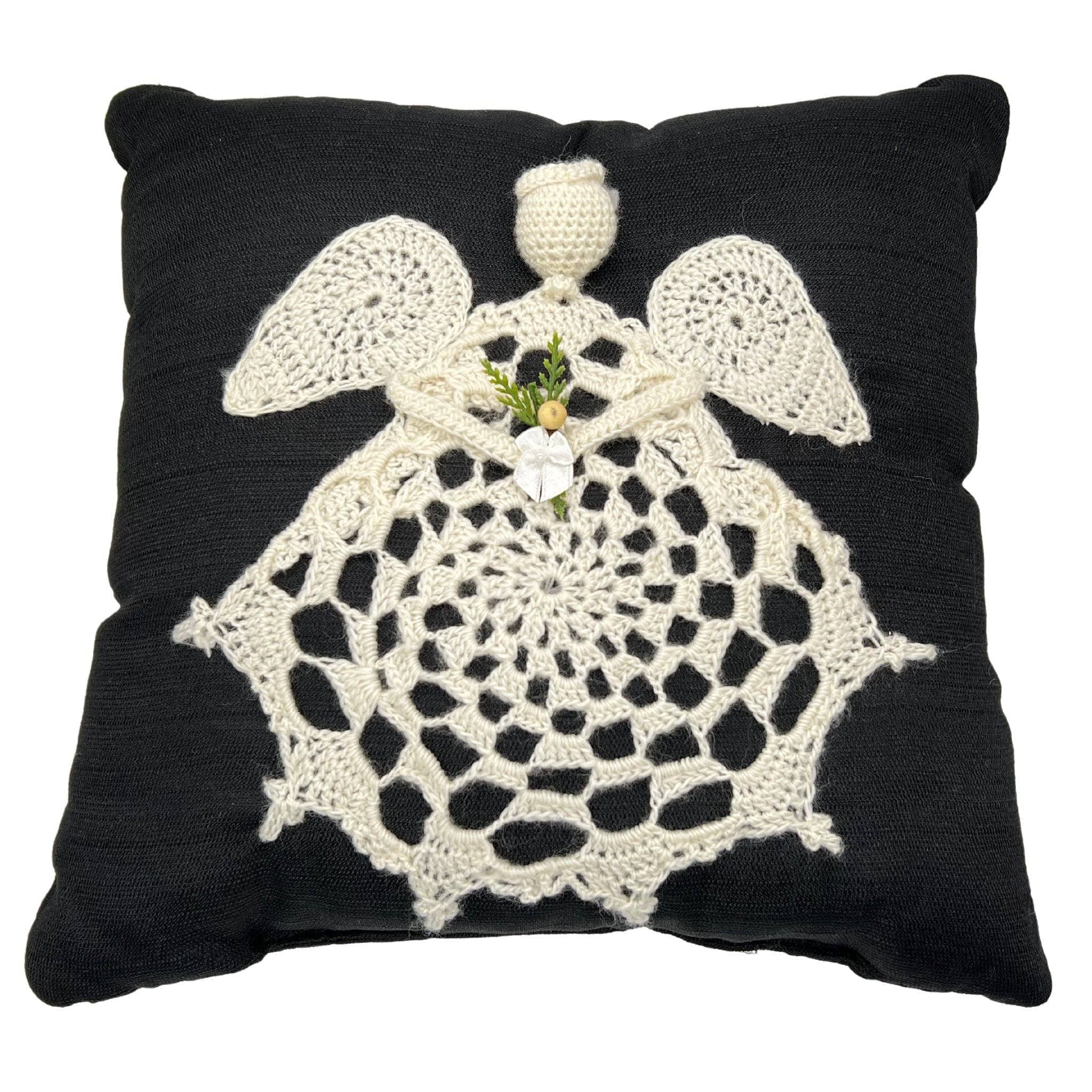 Traditional square throw pillow with angel applique in high-contrast black and cream knit fabric.