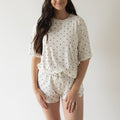 Woman wearing Annie bamboo short set with creamy off-white and charcoal polka dot print