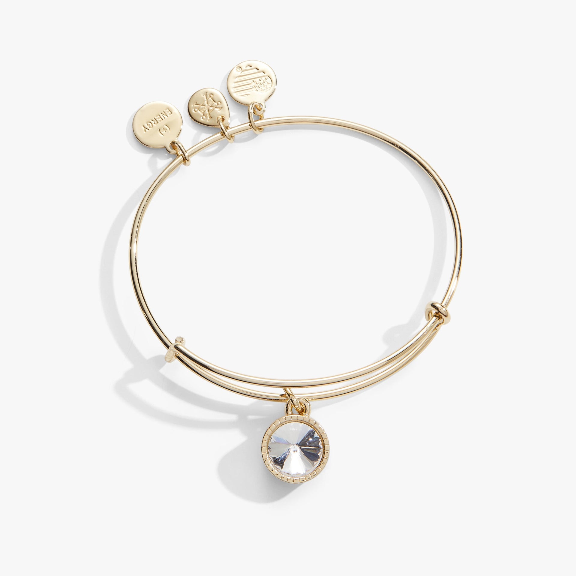 Silver tone April birthstone charm bangle featuring a single clear crystal.