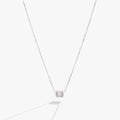 April birthstone pendant necklace with clear baguette crystals and a sliding barrel charm in gold.