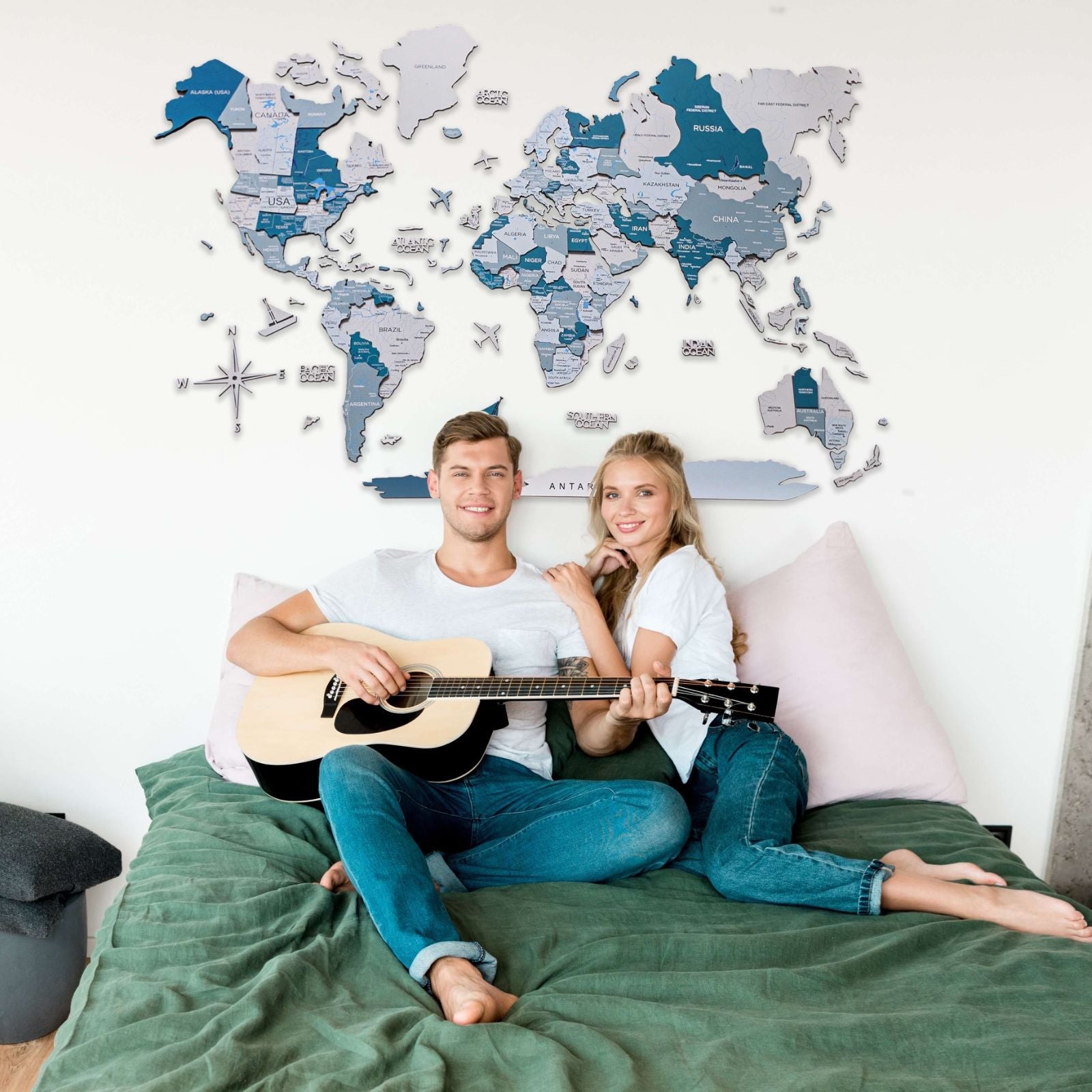 3D wooden world map featuring varying shades of aqua, navy, and ice blue