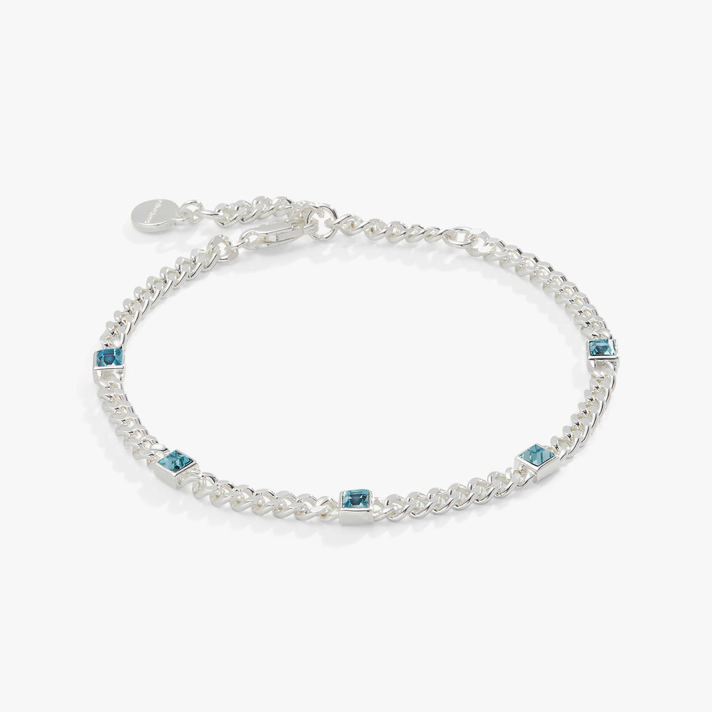 March birthstone bracelet featuring a faceted aquamarine gemstone on a gold curb chain.