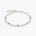 March birthstone bracelet featuring a faceted aquamarine gemstone on a gold curb chain.