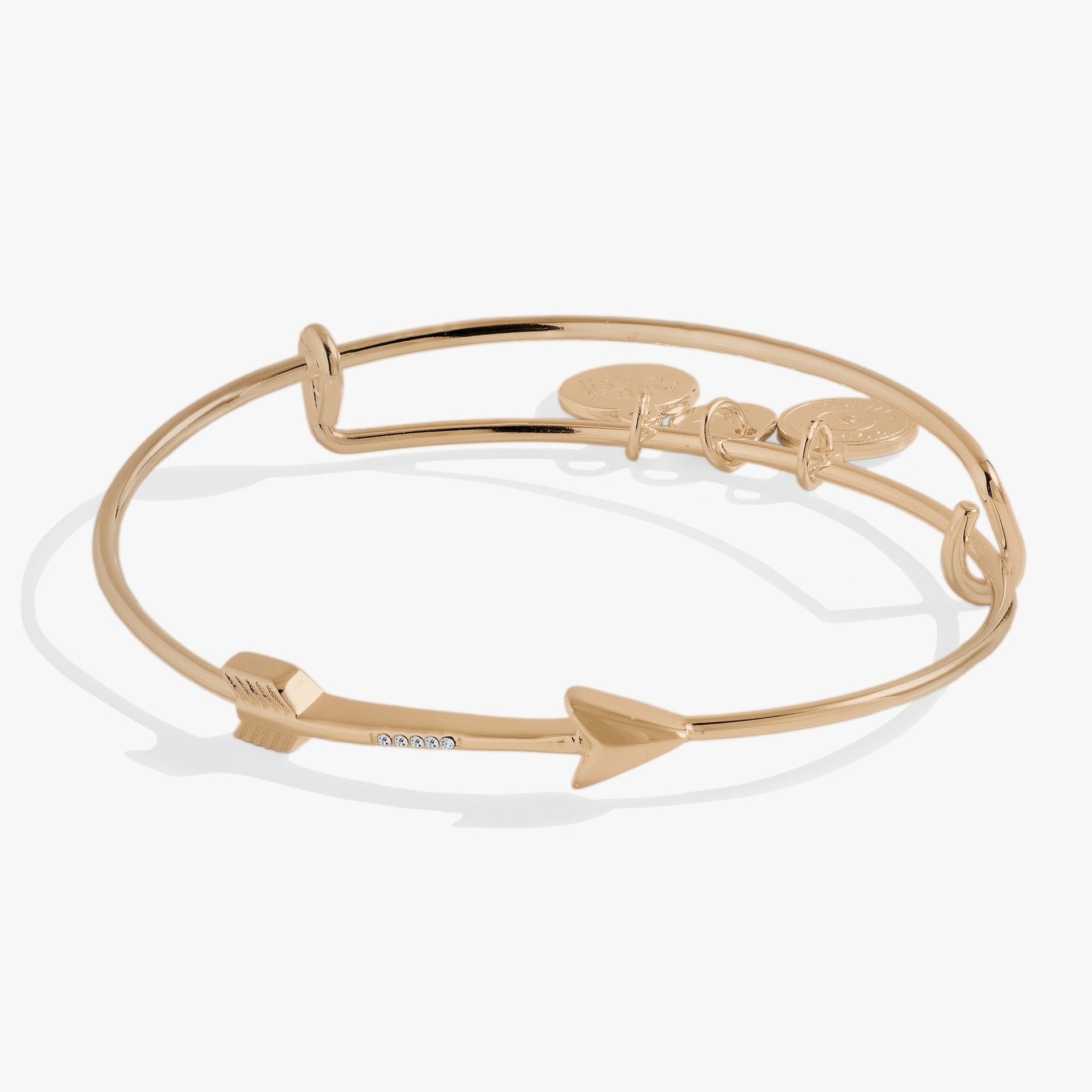 Silver-tone arrow motif bangle bracelet adorned with sparkling crystal accents.