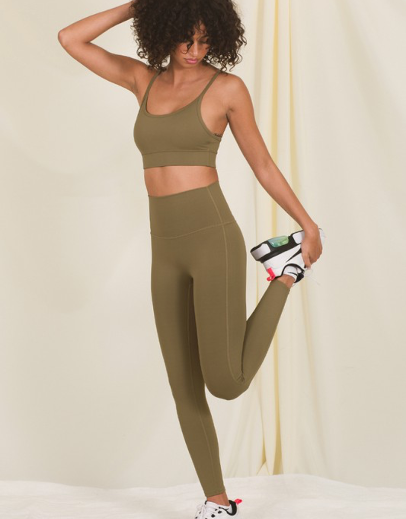 Full length high waisted leggings in dark olive color viewed from the side