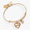 Gold-tone expandable bangle featuring a heart-shaped Mother of Pearl Aunt charm and a sparkling clear crystal.